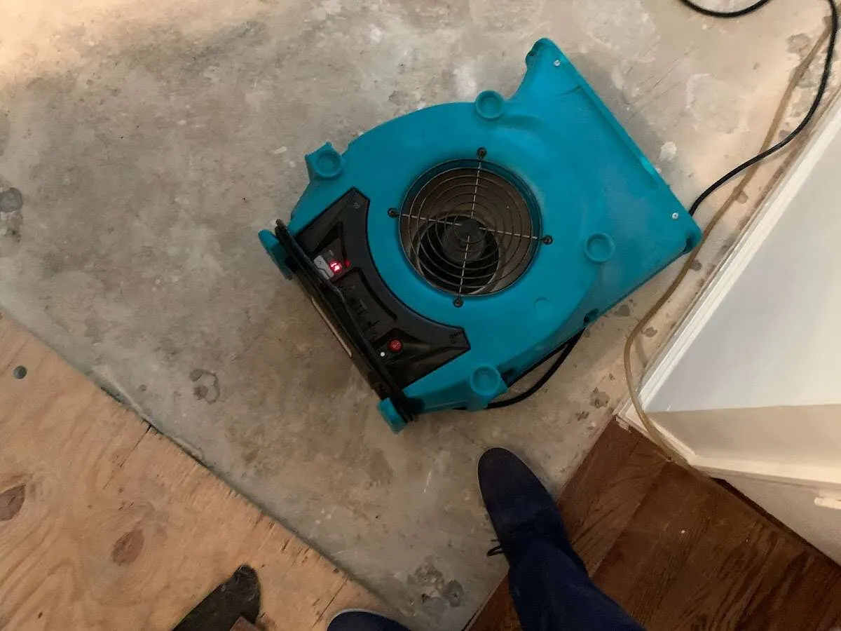 Air mover drying subfloor during Commercial Water Damage Restoration in Escanaba